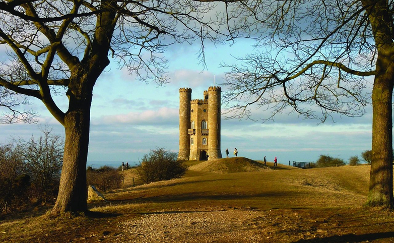 Broadway Tower in the village of Broadway, Cotswolds seen from a distance on a guided walking holiday
