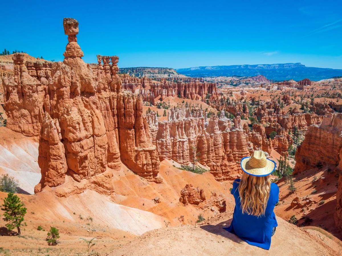 Young woman travels Bryce Canyon national park in Utah, United States, people travel explore nature. Bryce is a collection o…
