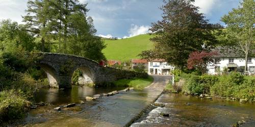 Exmoor village views with bridge over river on a walking with sightseeing holiday