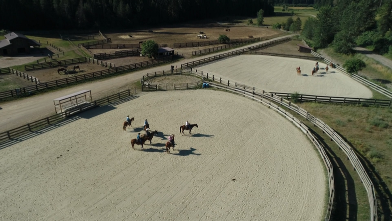 red-horse-mountain-ranch-property-aerial-horses.png