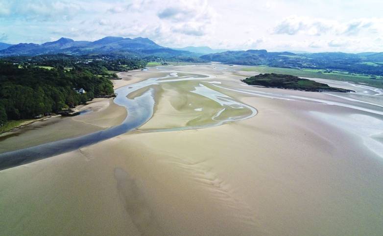 Aerial view, Drone panorama of Grifftan island on low tide sea in Snowdonia mountains in Wales