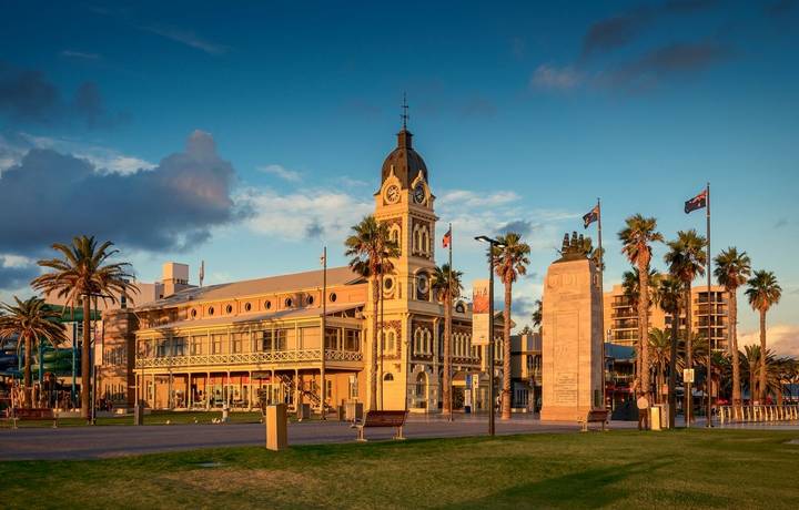 Adelaide, Australia - February 25, 2016: Glenelg Town Hall with Pioneer Memorial viewed through Moseley Square at sunset. Adelaide, Australia - February 25, 2016: Glenelg Town Hall with Pioneer Memorial viewed through Moseley Square at sunset.