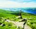Female hiker admiring the landscape on a path leading to the top of Ben Lomond in a sunny  day. Loch Lomond in the backgroun…