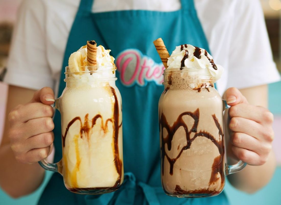 Large milkshake with snacks on top from Oties café in Liphook