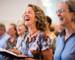 Caucasian woman singing in the church. Gospel singer singing. Joyful devotion, faith and belief in God religion concept.