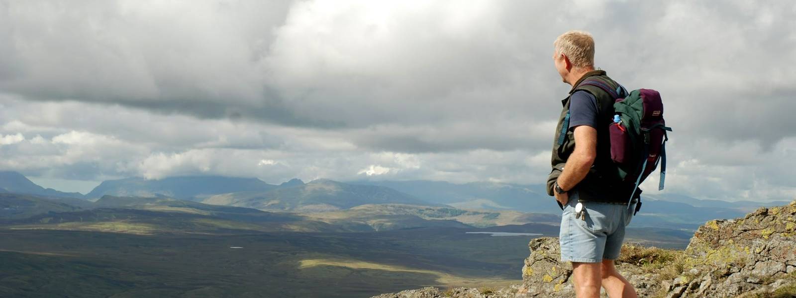 A climber on the summit of Arenig Fawr, Snowdonia, North Wales.