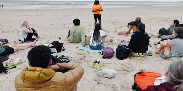 Woman in a red dress leading a salsa dance class