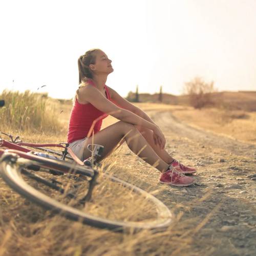 Woman resting from bike ride.