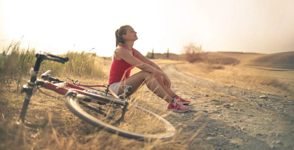Woman resting from bike ride.