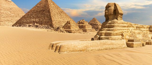 The Sphinx of Giza next to the Pyramids in the desert, Egypt.