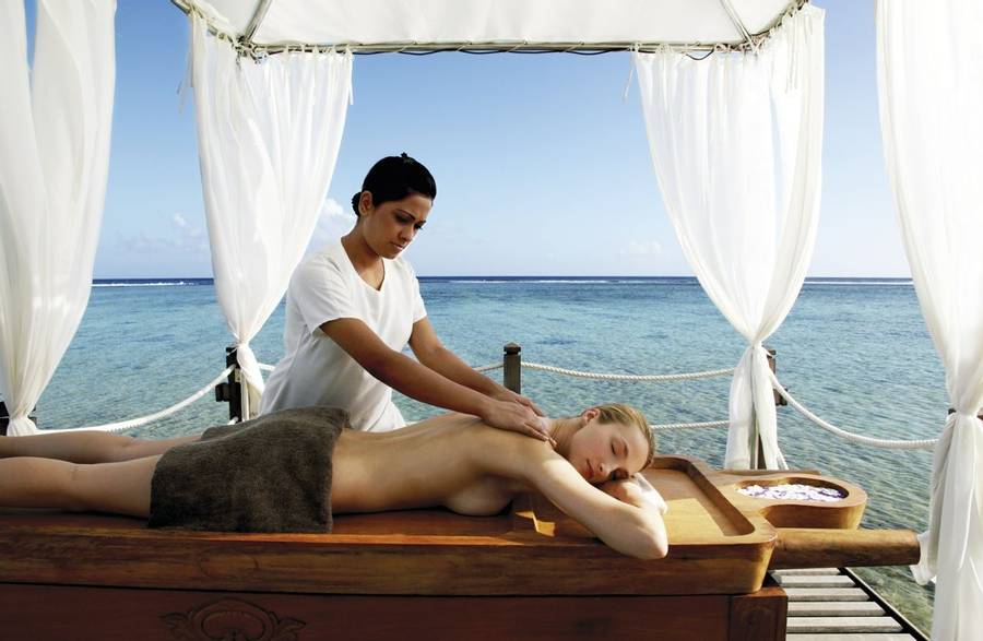 Woman receiving a massage on the beach at Shanti Maurice Resort and Spa in Mauritius