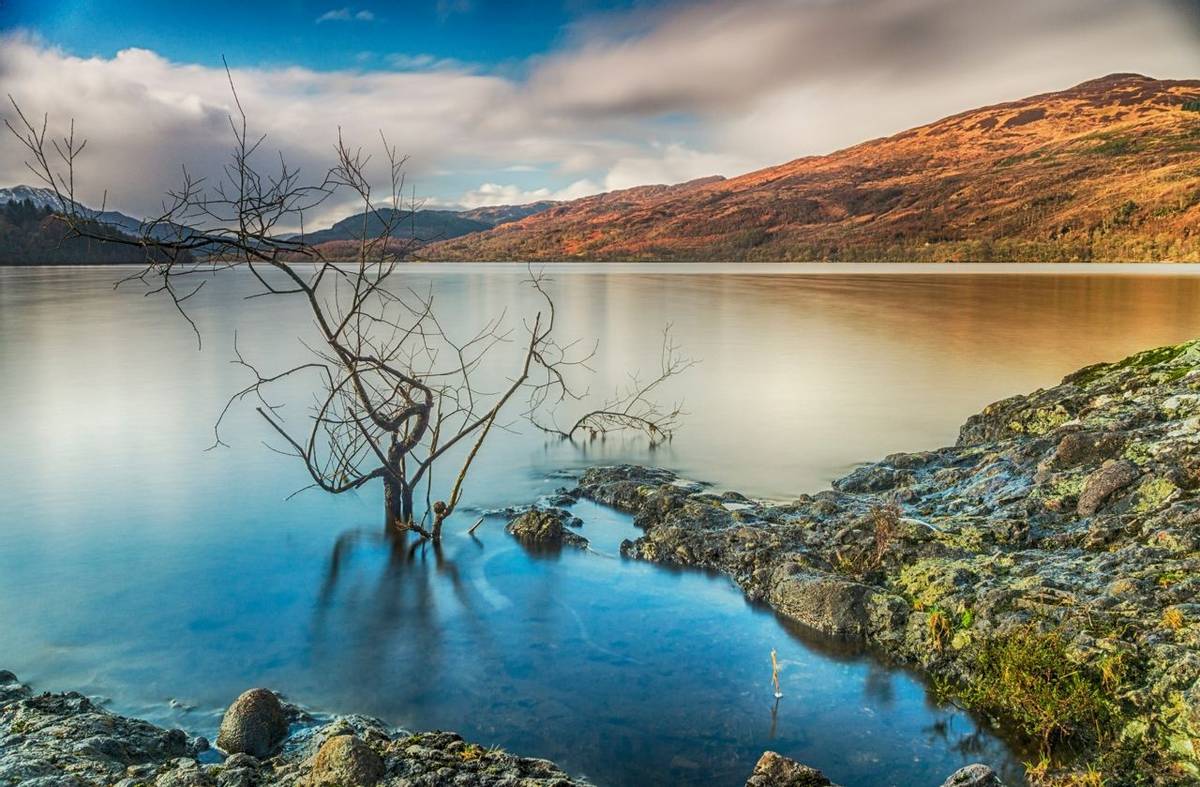 A long exposure shot looking west from the southern shore of Loch Venachar, in the Trossachs, Scotland
