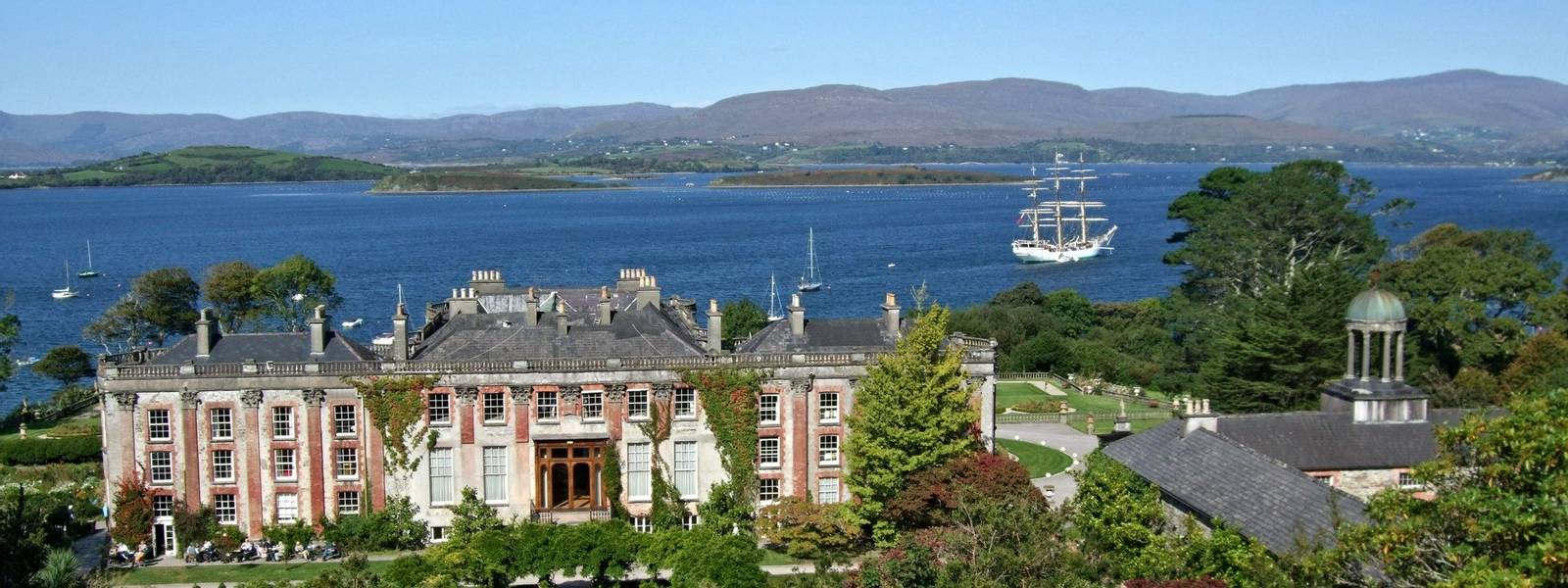 Bantry House in Ireland with sailboat in behind