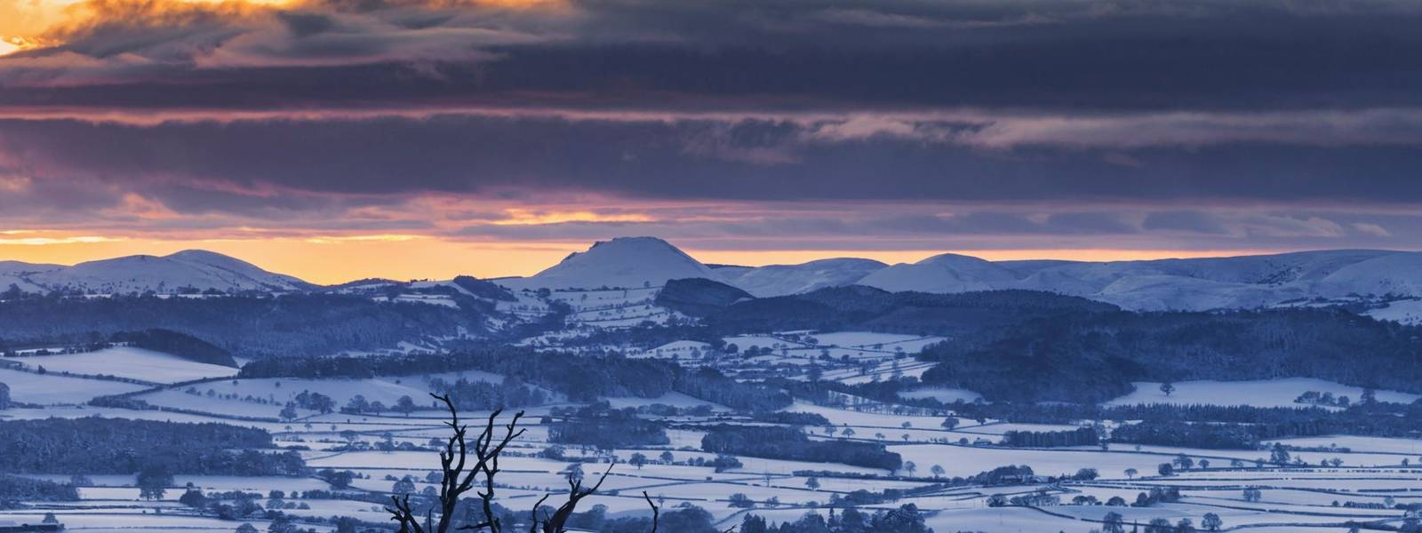 Sunset over Caer Caradoc in Shropshire Hills at winter in UK