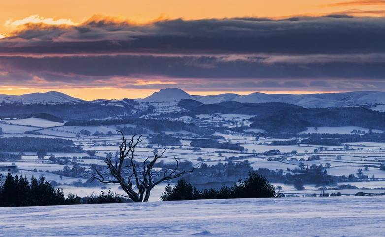 Sunset over Caer Caradoc in Shropshire Hills at winter in UK