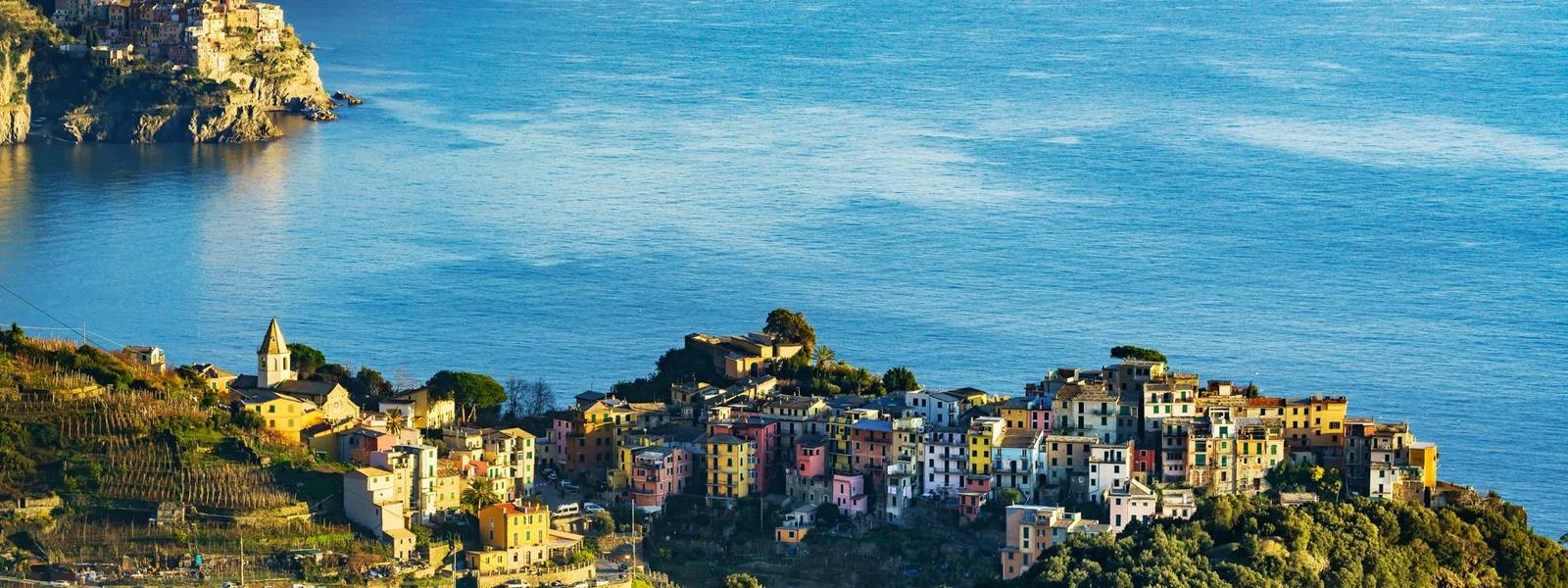 Corniglia village and Manarola in background at sunset. Cinque Terre, Ligury, Italy