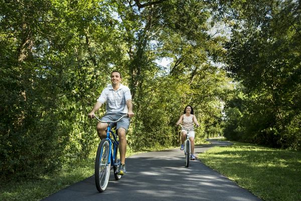 Family biking on a trail at The Woodlands resort.