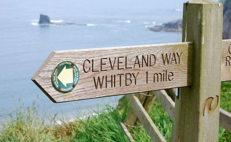 Cleaveland way signpost on edge of cliff outside Whitby, North Yorkshire, UK.