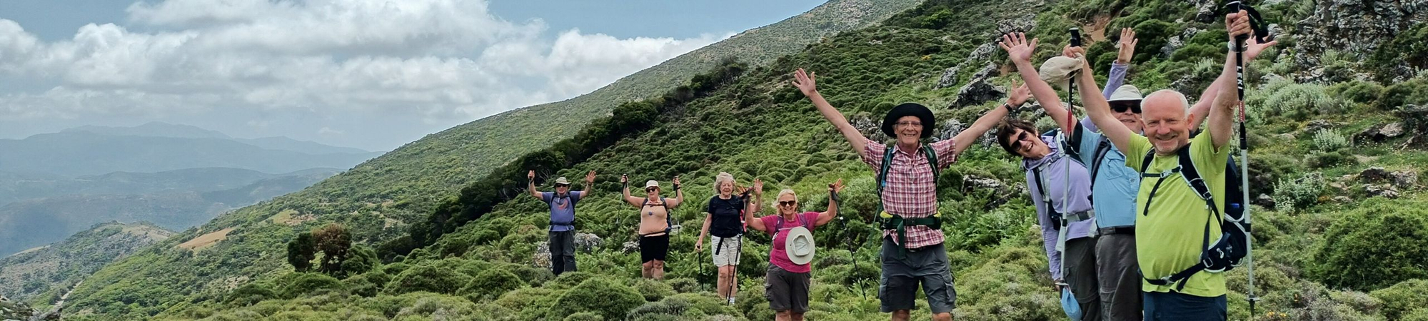 Joyful guided walking holiday group with leader
