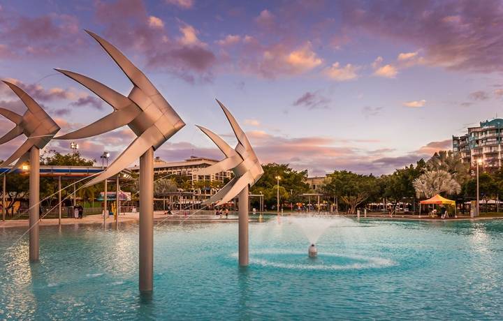 CAIRNS, AUSTRALIA - CIRCA AUGUST 2016: The Cairns Esplanade Lagoon at dusk, tropical north, Queensland, Australia CAIRNS, AUSTRALIA - CIRCA AUGUST 2016: The Cairns Esplanade Lagoon at dusk, tropical north, Queensland, Australia