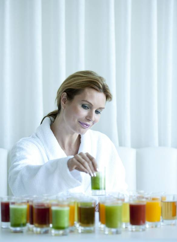 Woman sampling detox juices on a retreat at Longevity