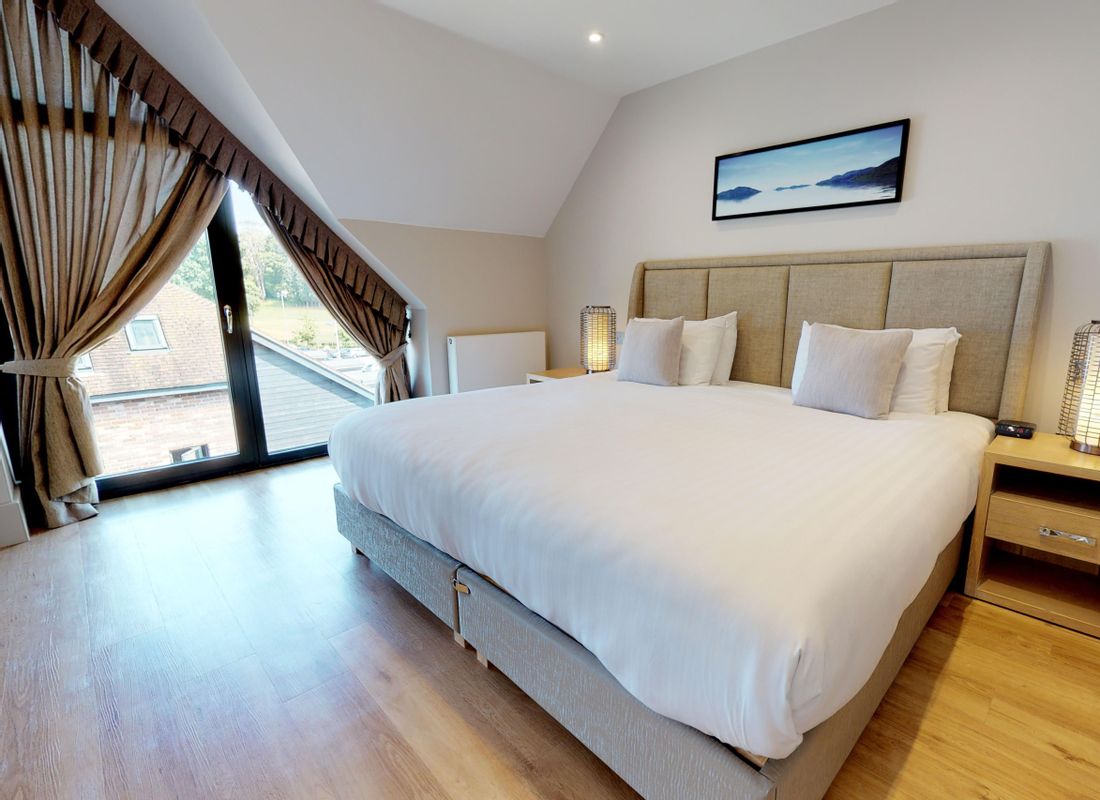 King sized bed in penthouse self-catering apartment