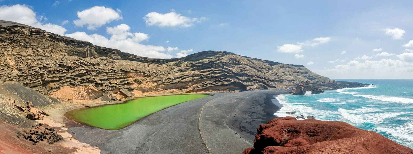 Panorama of Laguna Verde, a green lake near the village of El Golfo in Lanzarote, Canary islands, Spain