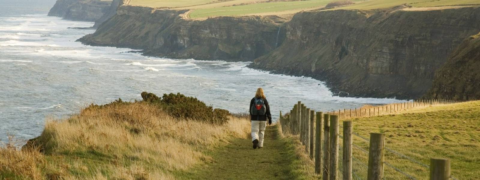 Walker on the coastal path, the Cleveland way in North Yorkshire, England, UK.