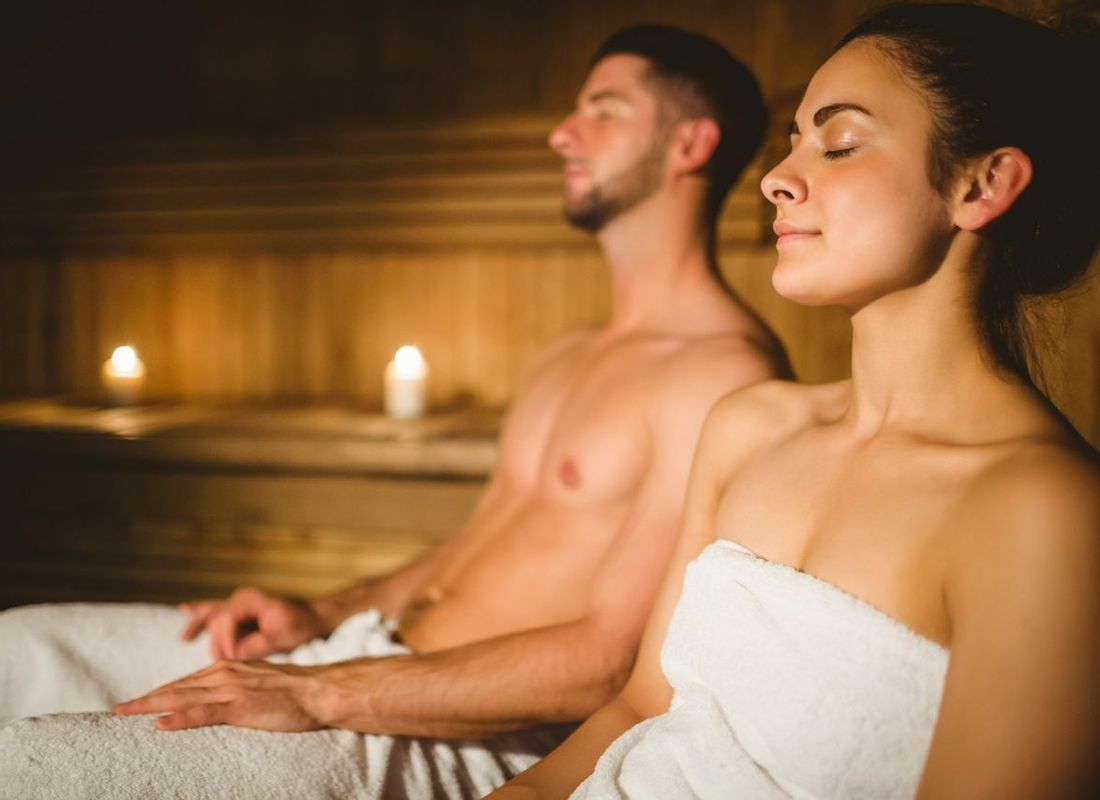 Couple relaxing inside hotel sauna