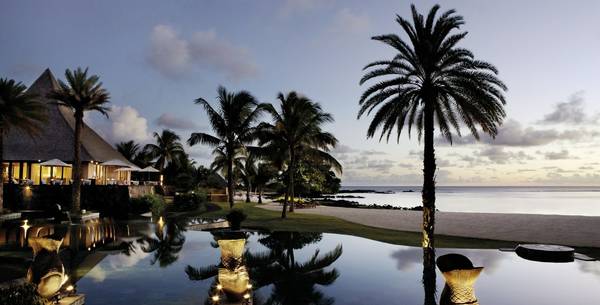 Pool and palm trees at Shanti Maurice Resort and Spa in Mauritius