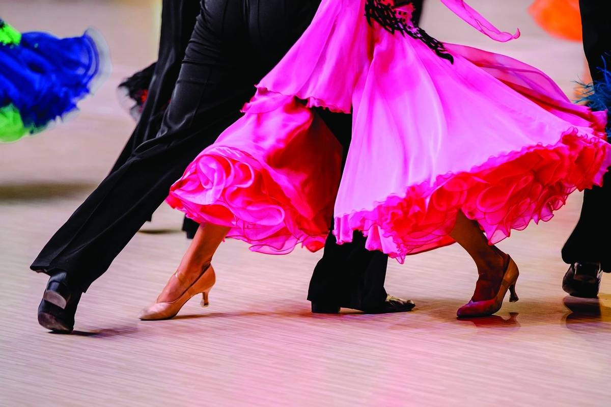 competitions in ballroom dancing. black tailcoat and pink ball gown