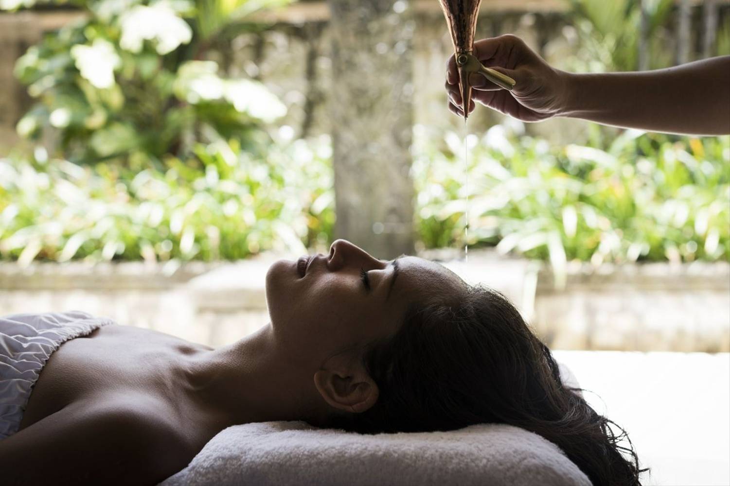 Woman receiving shirodhara treatment at Revivo Wellness Resort in Bali