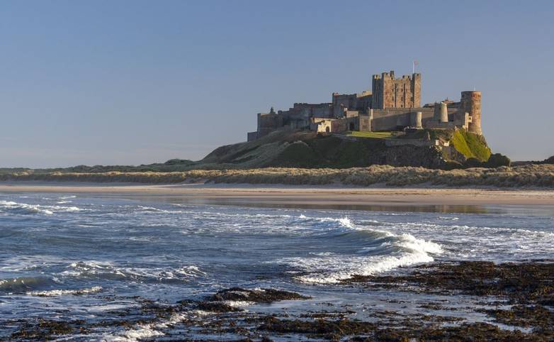 Bamburgh Castle on the northeast coast of England, by the village of Bamburgh in Northumberland. It is a Grade I listed buil…