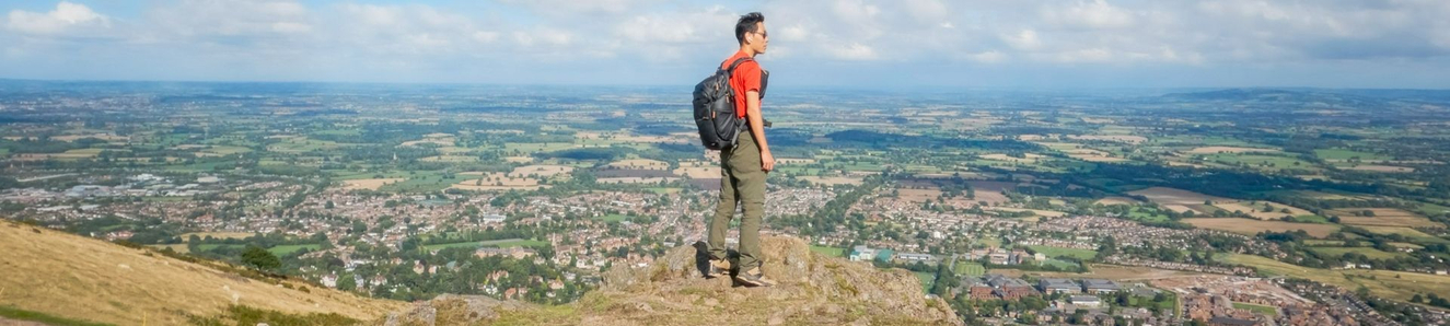 Active solo hiker on the peak of Malvern Hills, Worcestershire, United Kingdom.