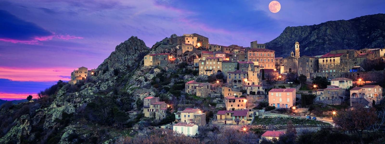 Full moon over Balagne village of Speloncato in Corsica