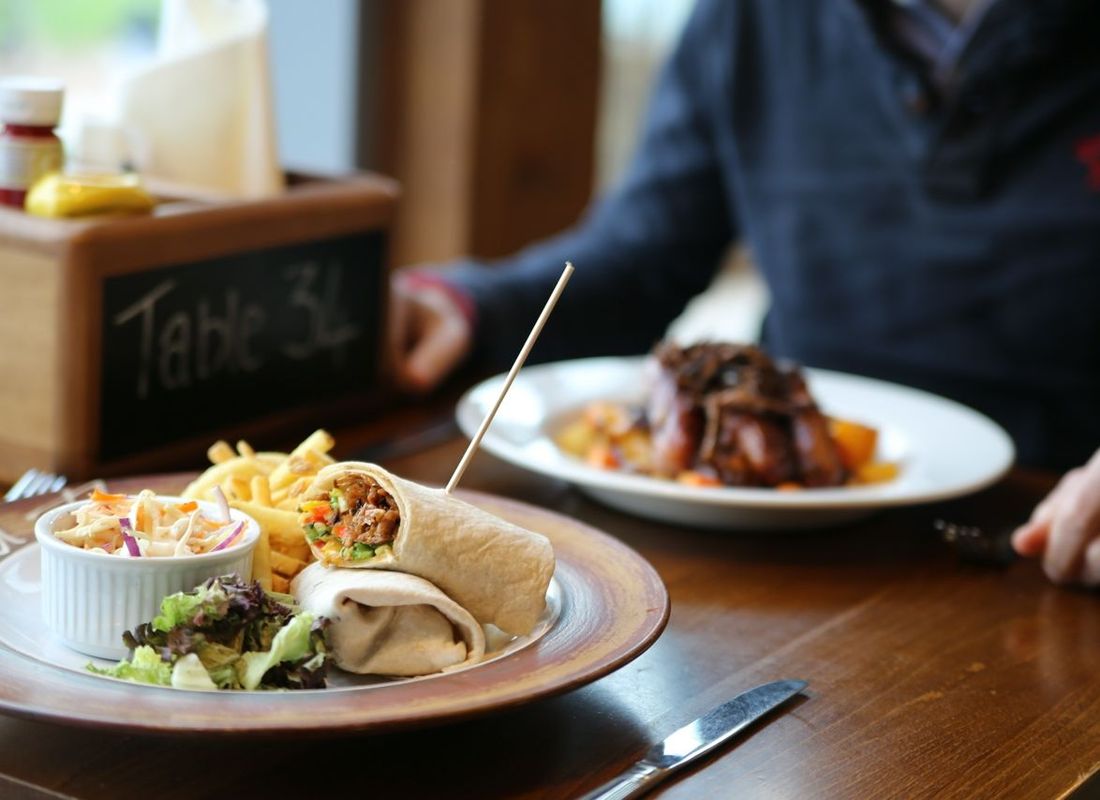 Healthy vegan friendly wrap served with coleslaw, chips and salad