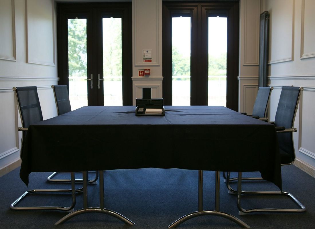 Small meeting room with window doors leading onto balcony