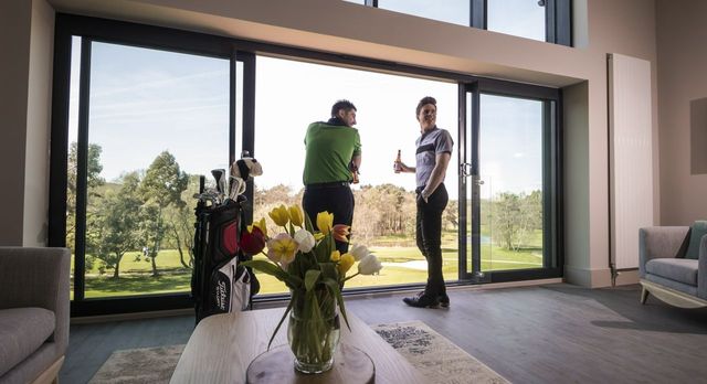 Friends overlooking golf course view from luxury apartment