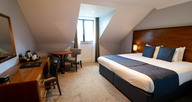 Cheersing drink of Prosecco in hotel swimming pool