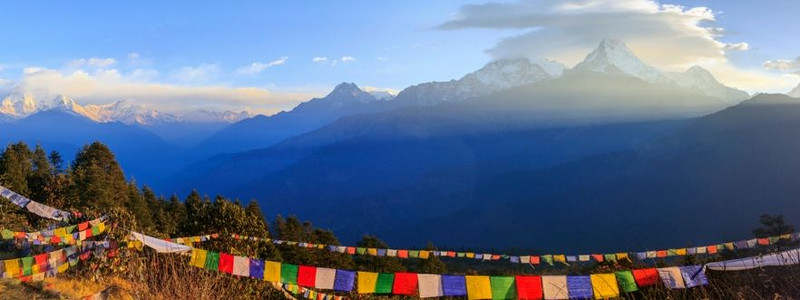 A long stretch of colourful prayer flags infront of the epic vistas of the himalayas in Nepal