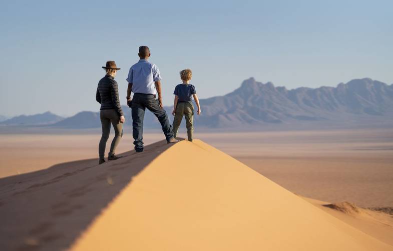 African Travel Inc - Namibia - Kwessi Dunes - Climbing the dunes.jpg