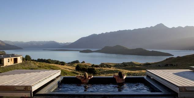 Couple looking out at the mountains from the swimming pool at Aro Ha in New Zealand