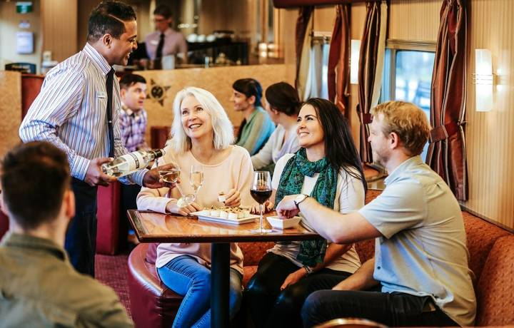 JBRE-On train-outback lounge-HA serving group of people wine.jpg JBRE-On train-outback lounge-HA serving group of people wine.jpg