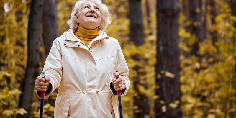 Older lady walking by herself in woods