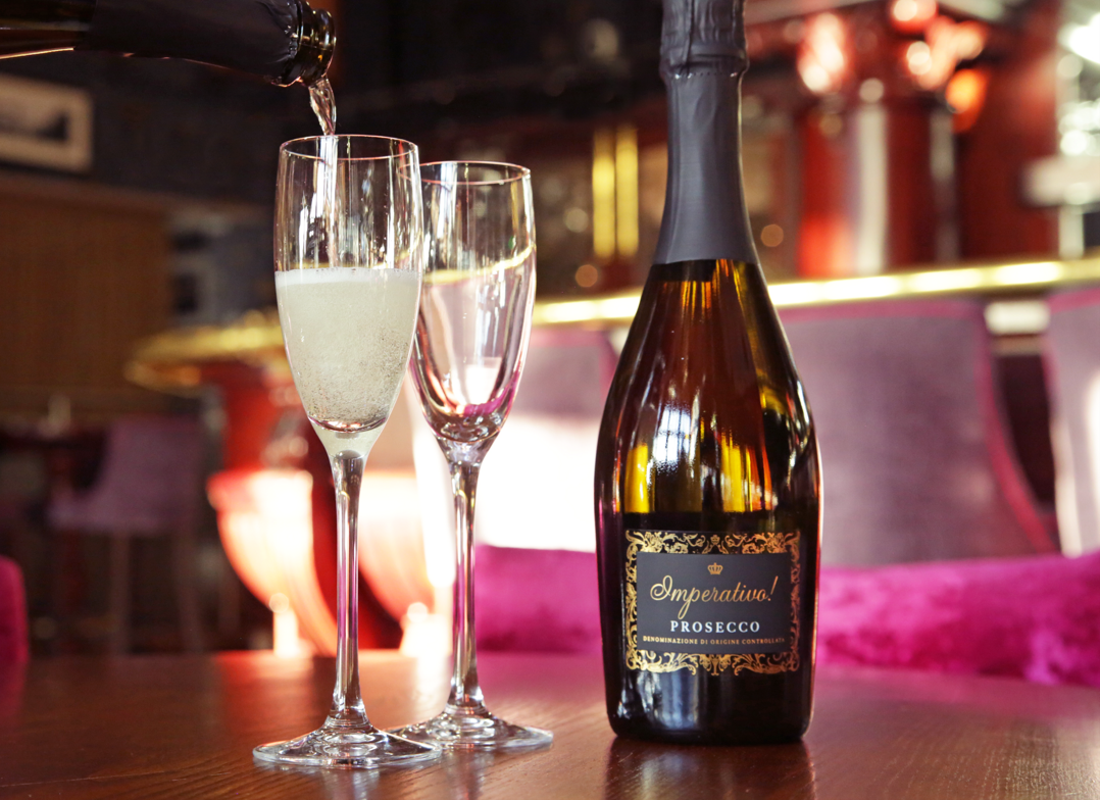 Two glasses of Prosecco being poured inside the Atrium Champagne Bar