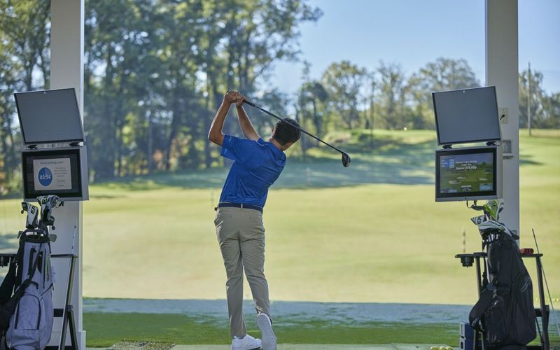 Person using Toptracer facilities on golf driving range