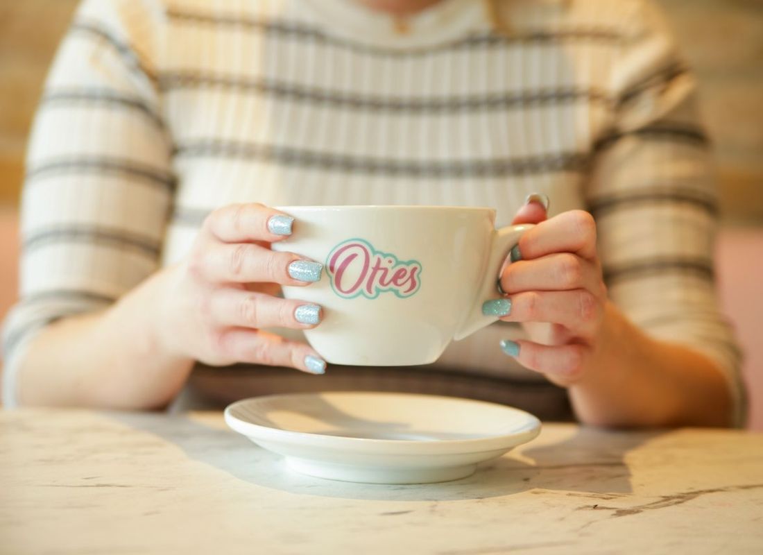 Coffee being held warming up hand in Oties shop