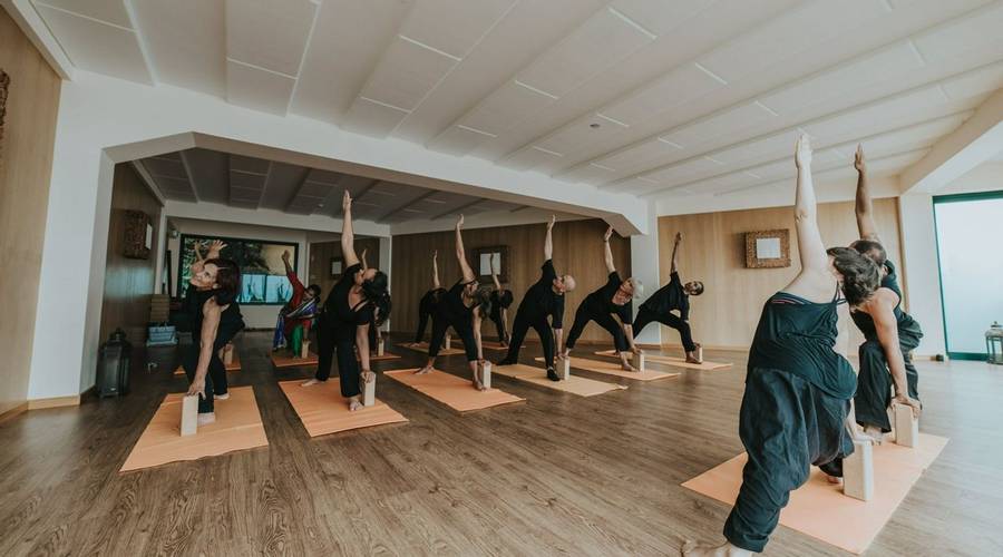 Group indoor yoga class at Galo Resort in Madeira, Portugal