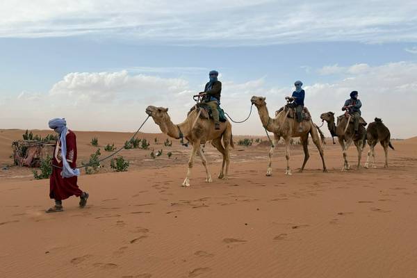 Mike (left) enjoying a camel ride Image