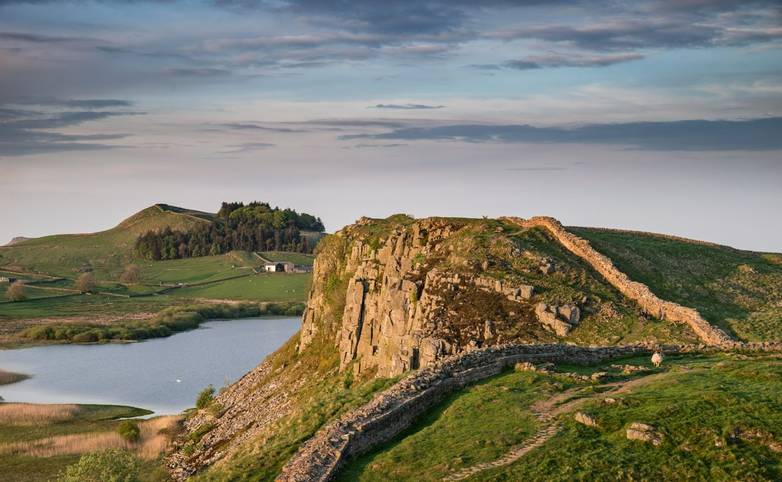 Beautiful landscape image of Hadrian's Wall in Northumberland at sunset with fantastic late Spring light